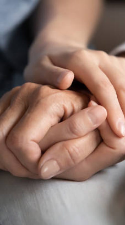 I know you can. Close up of millennial woman grown daughter, grandchild or younger friend holding tight hand of old mother, grandmother, elder relative or colleague helping to overpass life problems